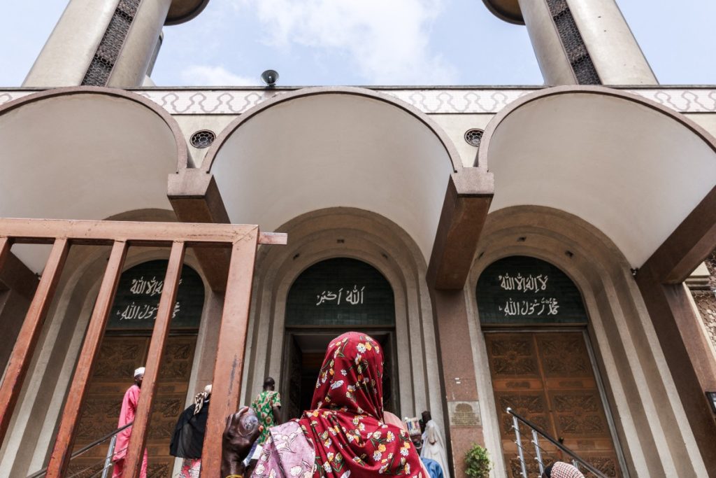 A woman stands in front of the Lagos Central Mosque in Lagos on March 8, 2024, ahead of the holy fasting month of Ramadan. (Photo by Benson Ibeabuchi / AFP)