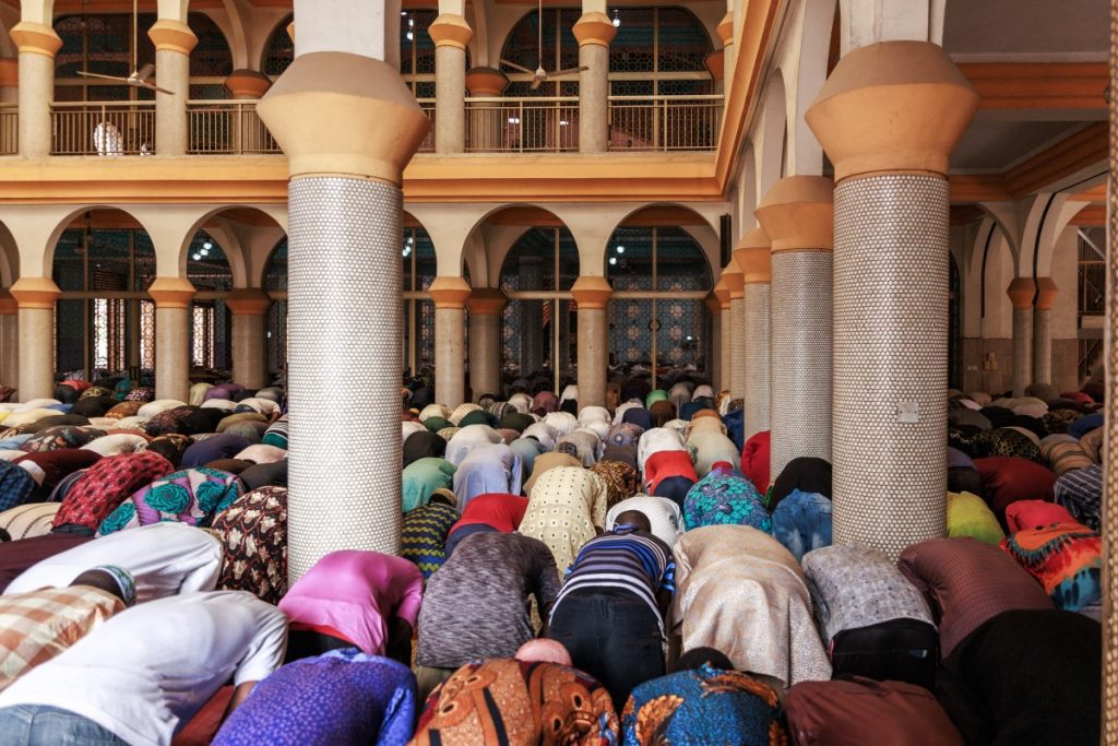 People perform the Friday prayer at the Lagos Central Mosque in Lagos on March 8, 2024, ahead of the holy fasting month of Ramadan. (Photo by Benson Ibeabuchi / AFP)