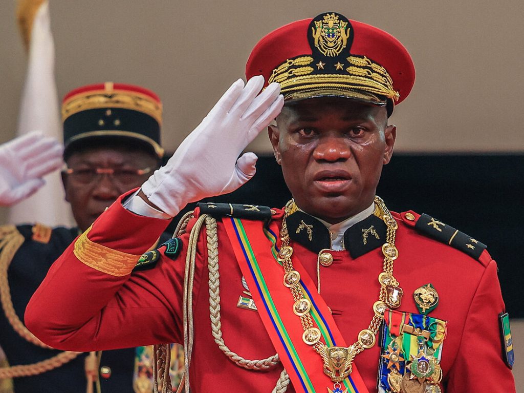 Gabon's new strongman General Brice Oligui Nguema (R) salutes as he is inaugurated as Gabon's interim President, in Libreville on September 4, 2023. Gabon's coup leader vowed after being sworn in as interim president