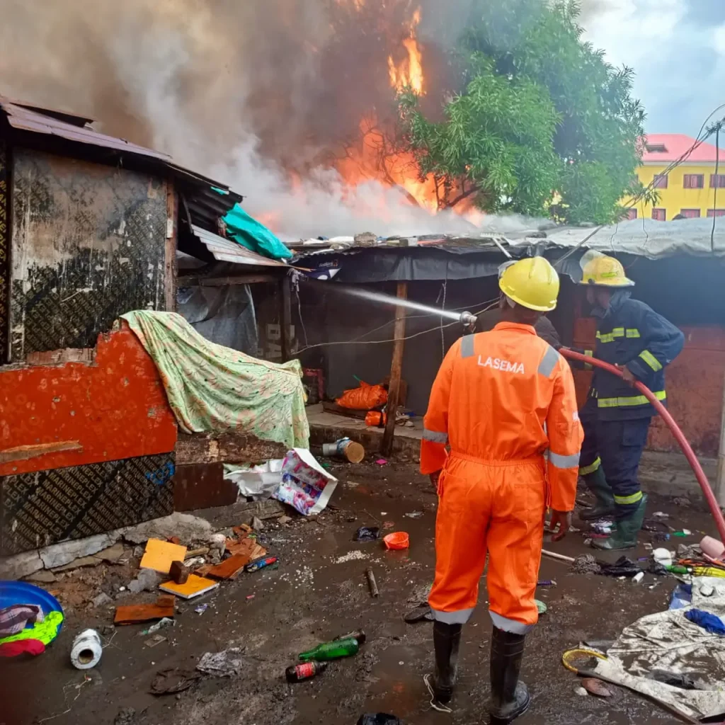 Fire fighters quell the fire at Tejuosho market